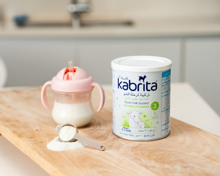 kabrita infant formula stage 3 tin with a scoop and sippy cup