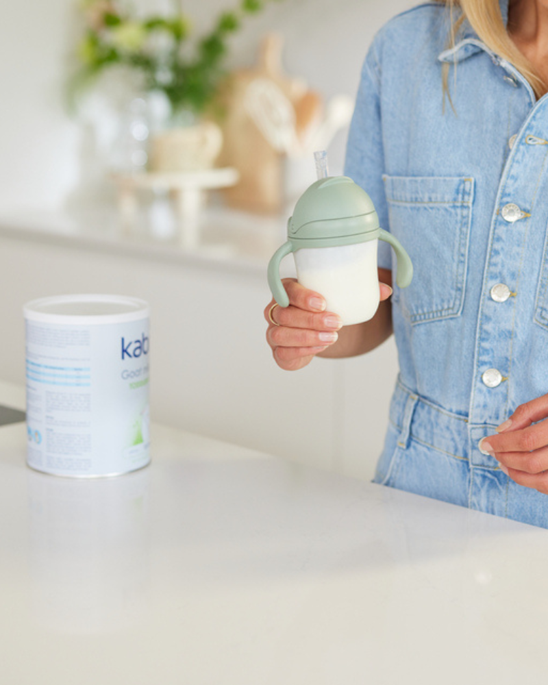 Mother preparing Kabrita infant formula