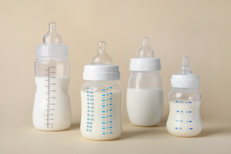 Assorted baby bottles filled milk– representing Kabrita goat milk formula and bottle feeding essentials for newborns