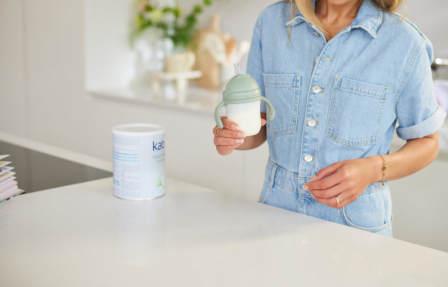mother preparing formula bottle